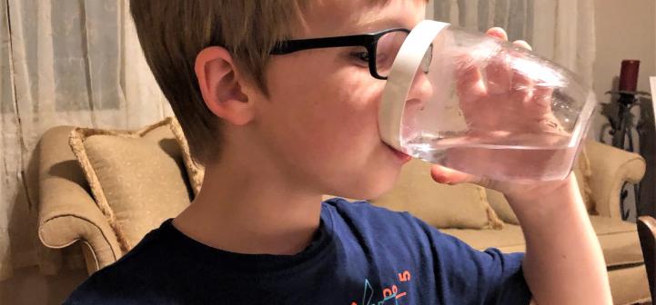 boy drinking cup of water